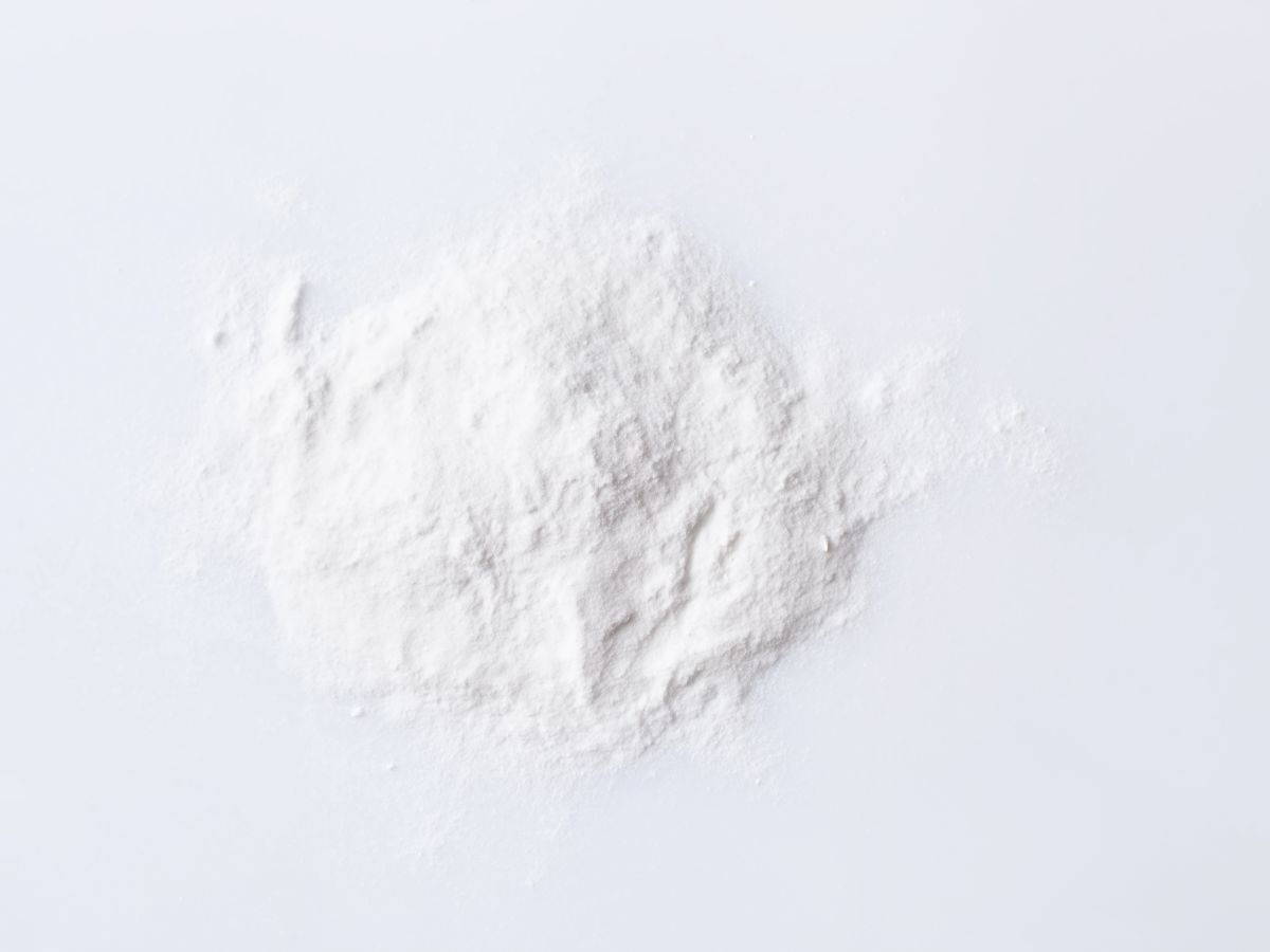 Light hair dry shampoo scattered on a white background. 