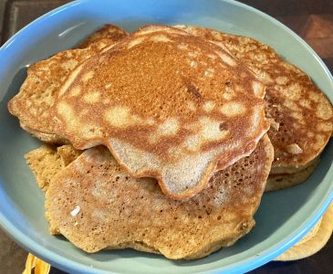 Stack of sourdough pancakes made from discard on a blue plate