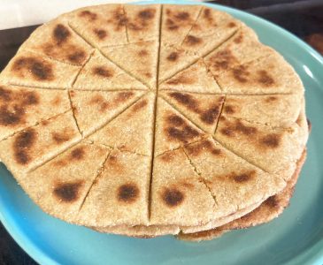 Homemade unleavened communion bread on a blue plate