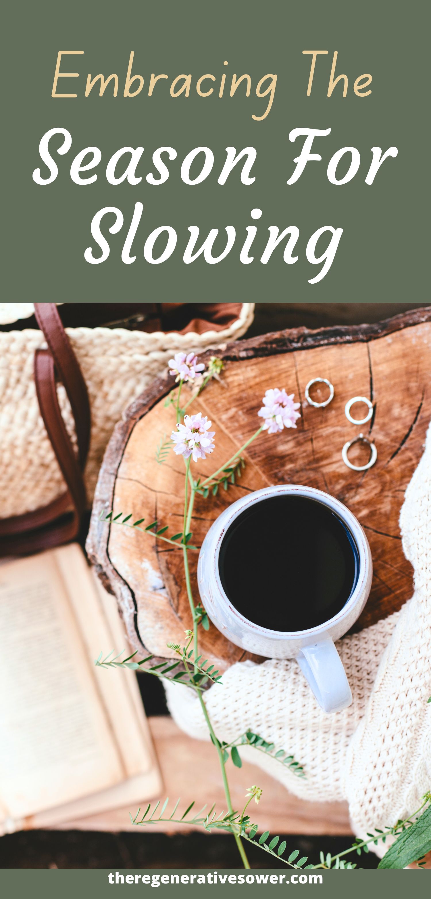 white mug of coffee on a wooden table with flowers and a book and white handbag on the floor next to it with the text embracing the season for slowing theregenerativesower.com