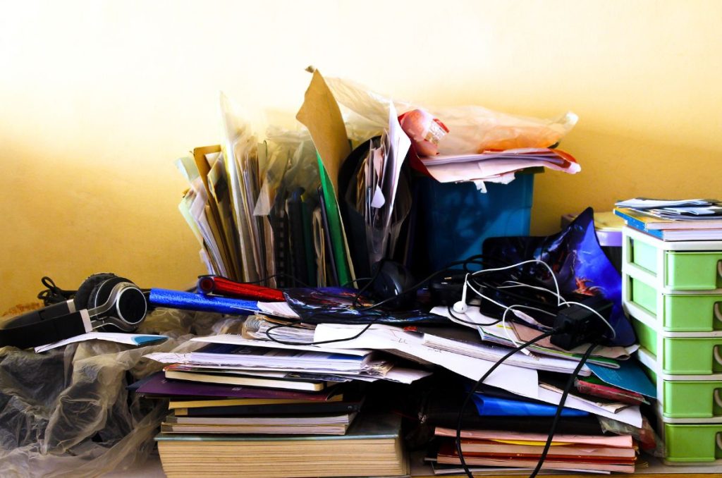 cluttered desk space of a person working toward minimalism