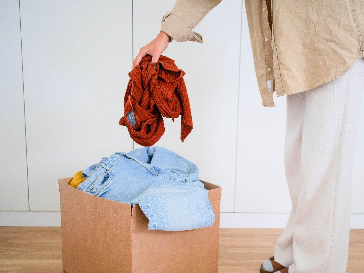 woman practicing minimalism by decluttering unused clothes
