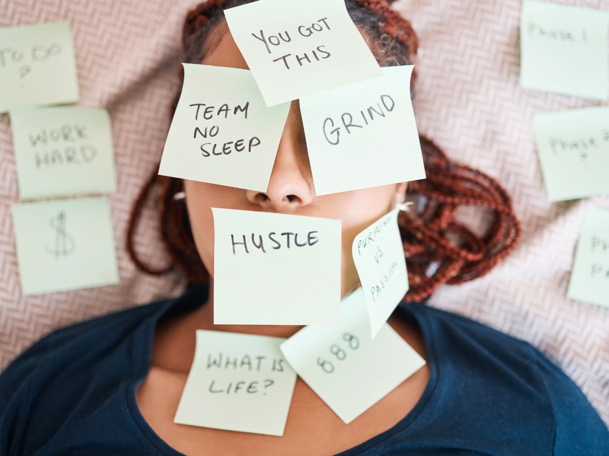 woman's face laying down with a several sticky notes attached to her face with items for her to do list