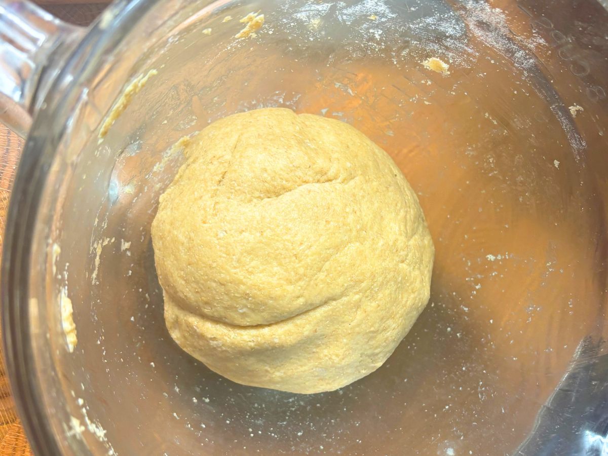 smooth ball of homemade flour tortilla dough in a glass bowl