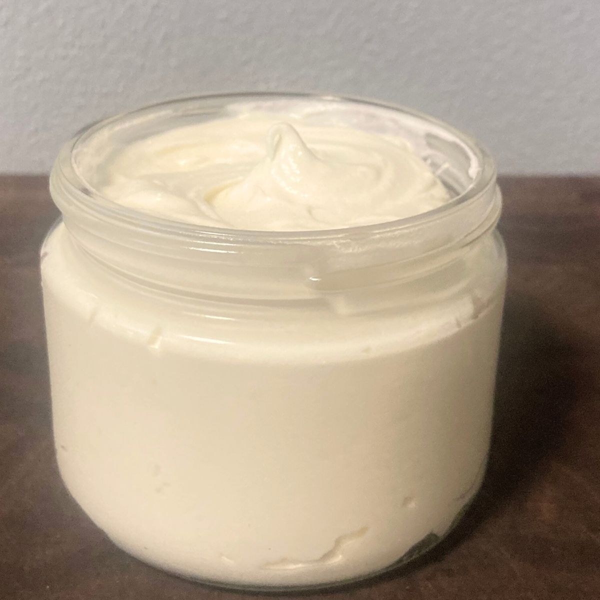 clear glass jar of non-toxic body lotion made from beef tallow