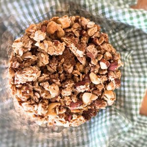 homemade cinnamon roll granola in a glass cookie jar