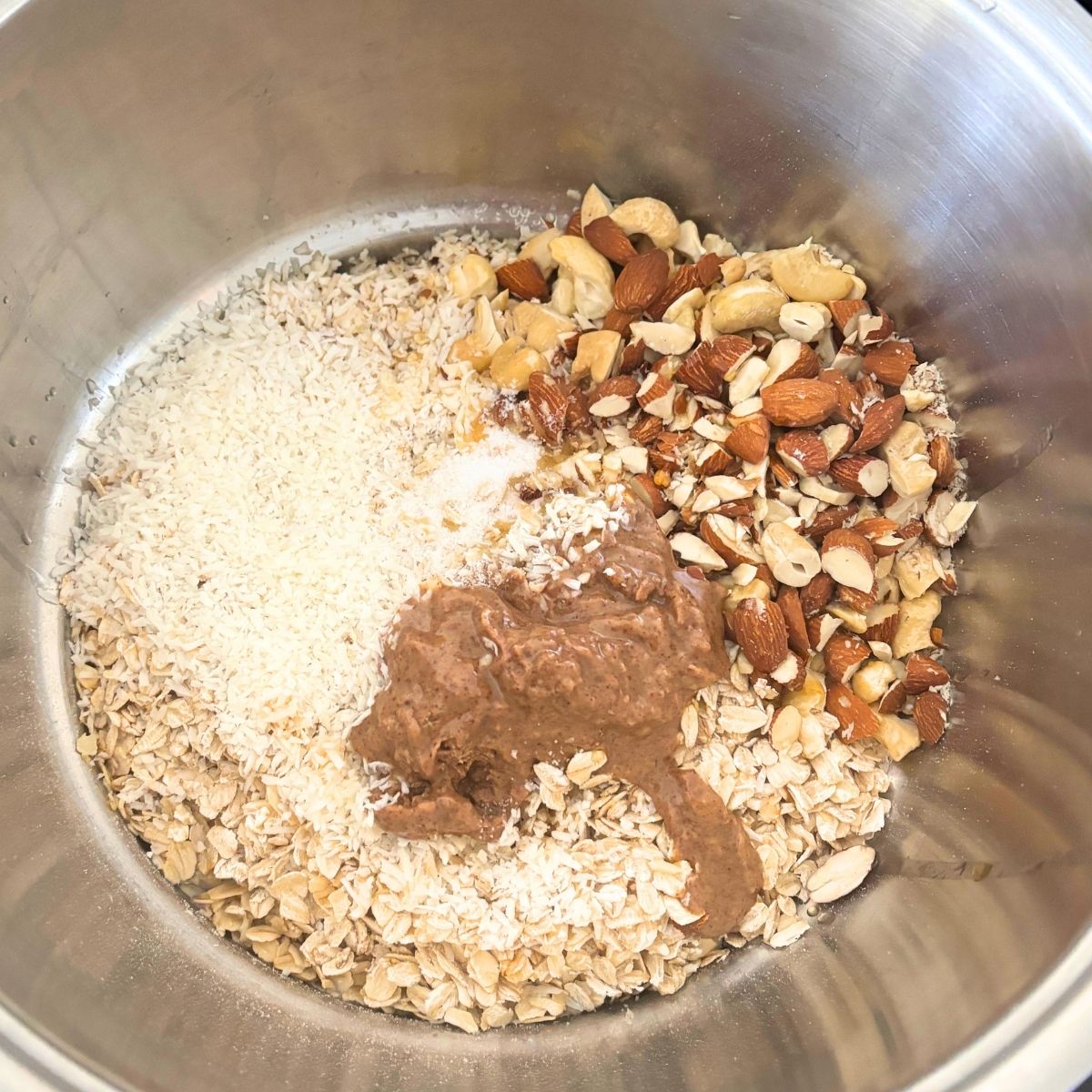 homemade cinnamon roll ingredients poured all together in a stainless steel pot but not yet mixed together