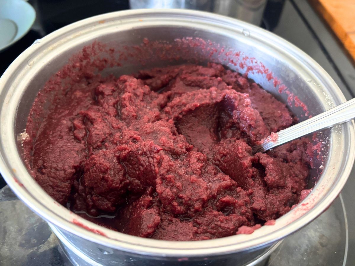 grape juice that has been bloomed with grass-fed beef gelatin in sauce pan with a stainless steel spoon