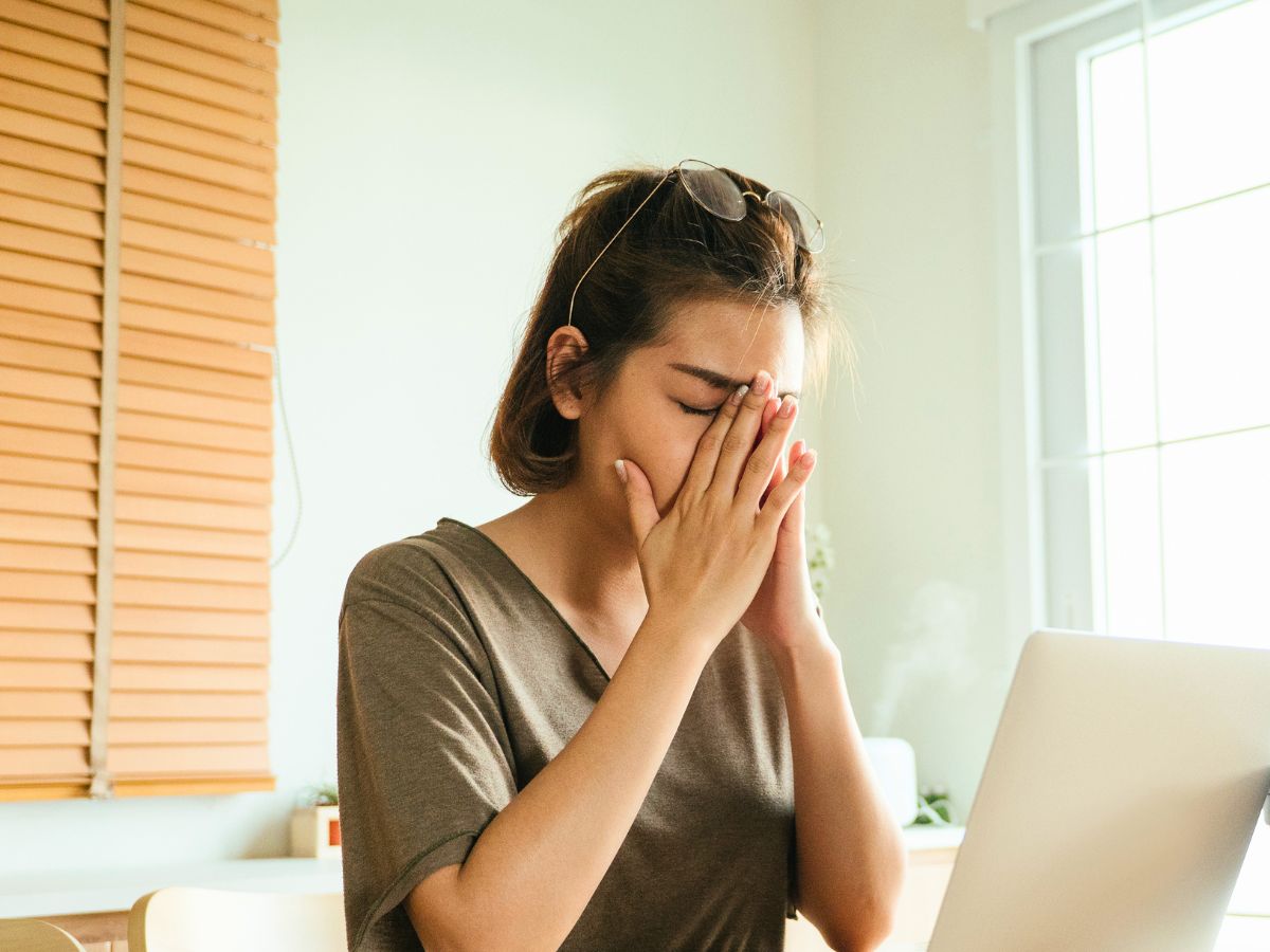 woman sitting at a computer feeling frustrated