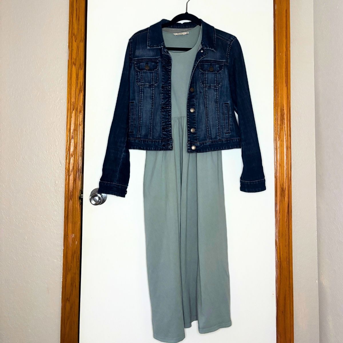 light blue dress with a jean jacket hanging in front of a white door