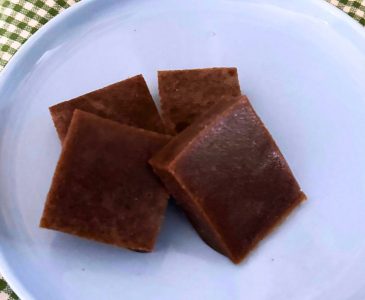 four homemade beef gelatin gummy candy squares on a light blue plate
