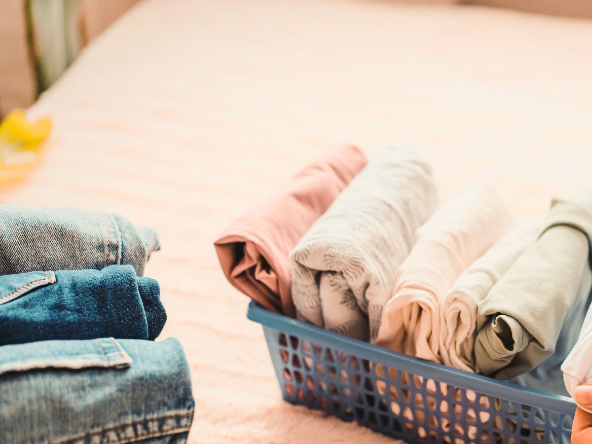 ten item capsule wardrobe folded neatly into two small baskets